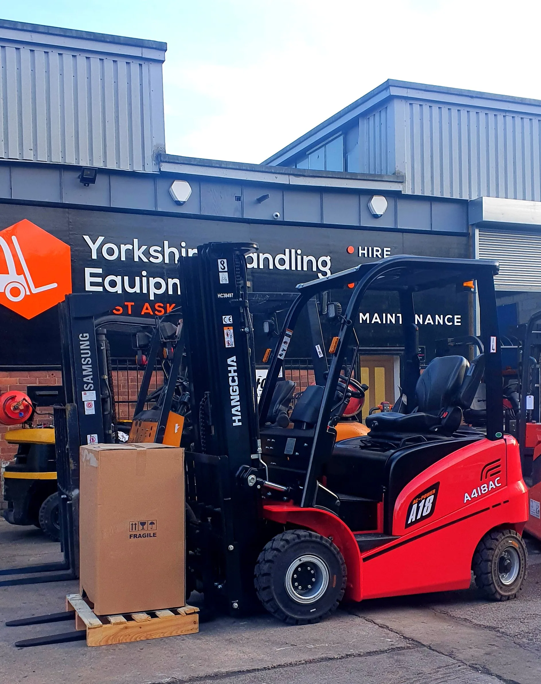 Hangcha forklift beside a boxed delivery outside the original unit