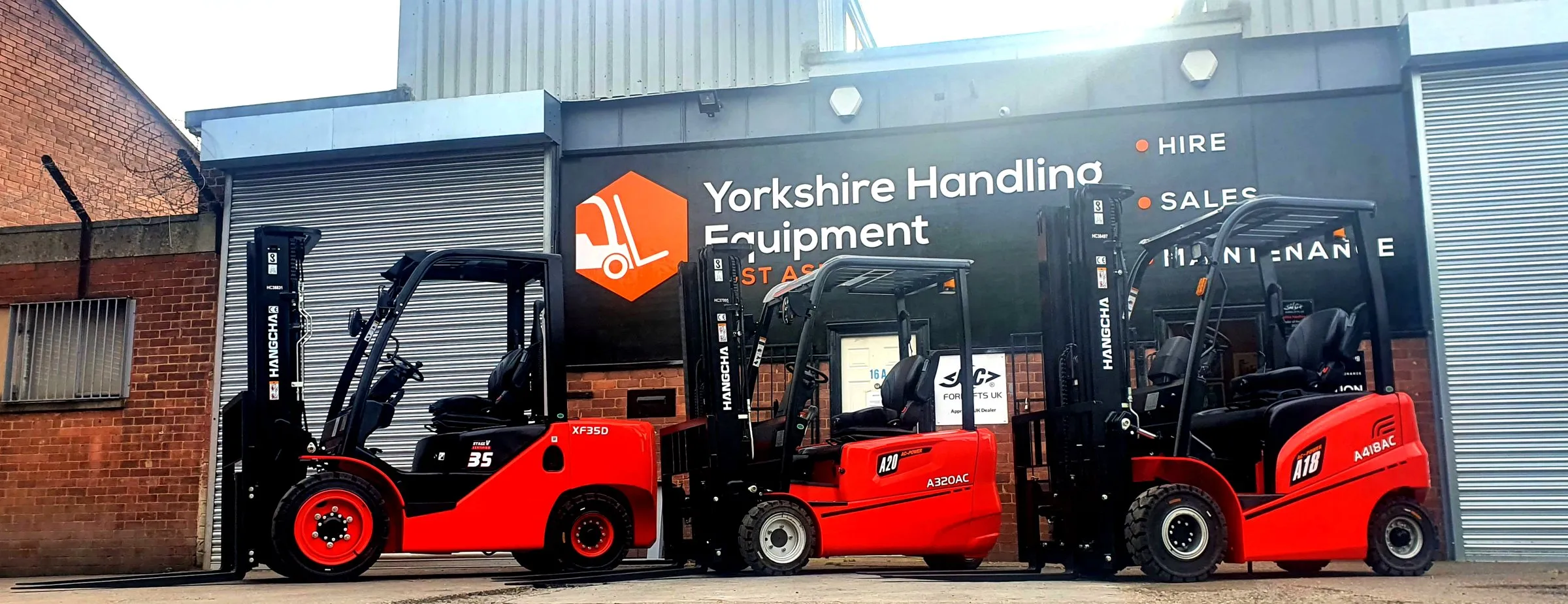 New Hangcha forklifts outside the original Yorkshire Handling Equipment unit and sign